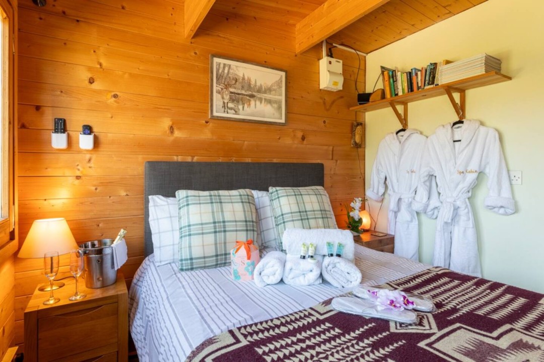 Bed, bedside cabinet and dressing gowns - The Spa Cabin