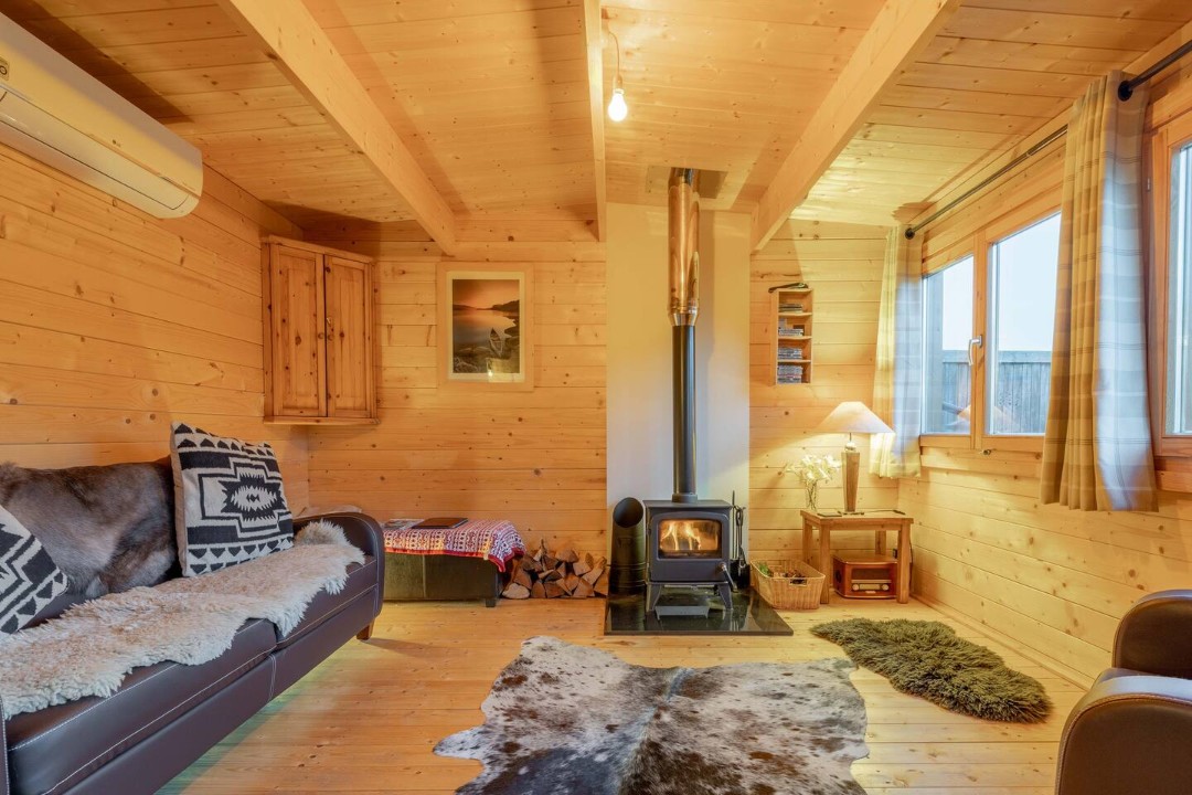 Sofa and Wood Burner - The Spa Cabin
