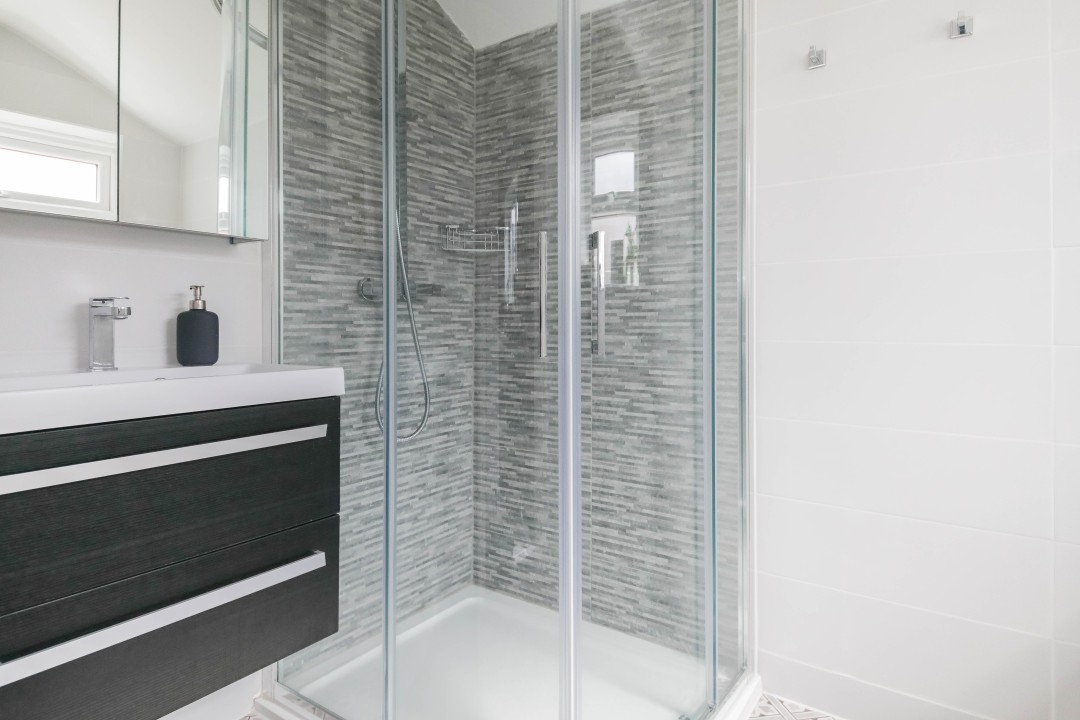 downstairs bathroom with walk in shower, WC & basin