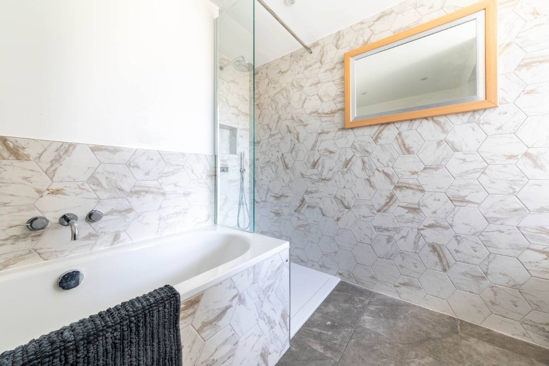 family bathroom with bath, walk in shower and wc- Eden Cottage