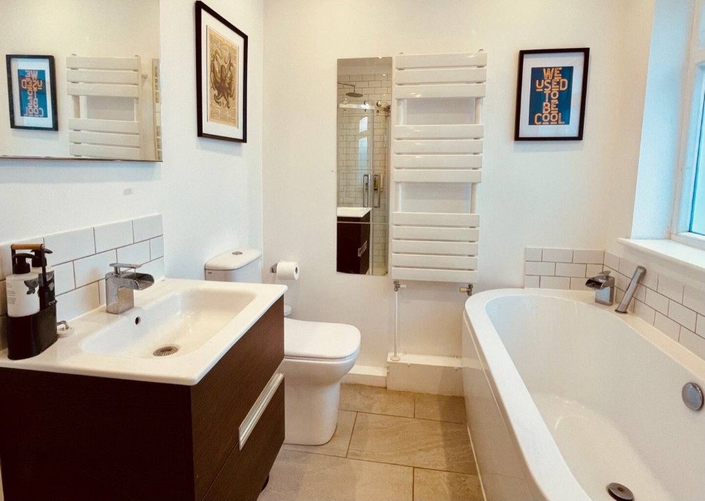 Large downstairs bathroom with separate bath, wash basin, shower cubical, and toilet. - Seal Cottage