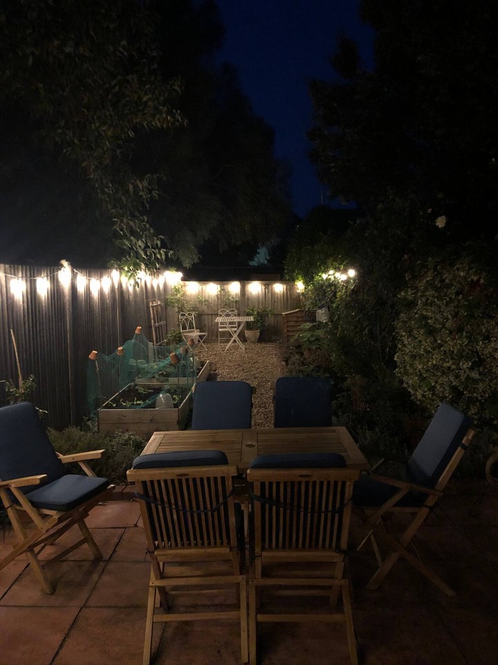 Rear garden with string lighting to create a relaxing atmosphere - Juniper Cottage
