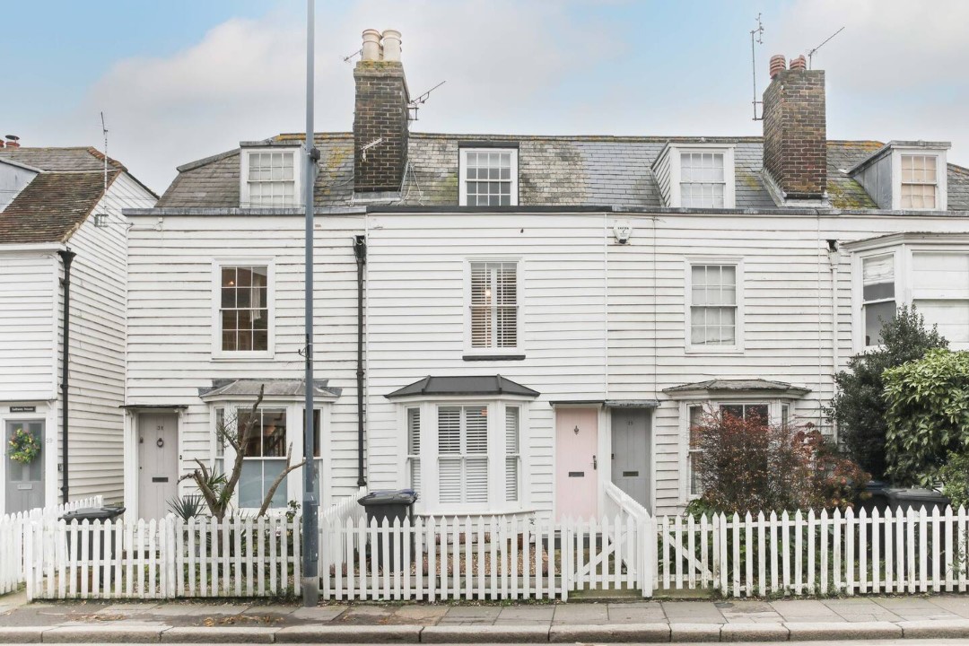 White ship-lapped cottage with white picket fence - Juniper Cottage